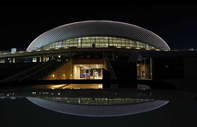 The Bolshoy Ice Dome is reflected  in the roof of a car during final preparations for the 2014 Winter Olympics, Monday, Feb. 3, 2014, in Sochi, Russia. 