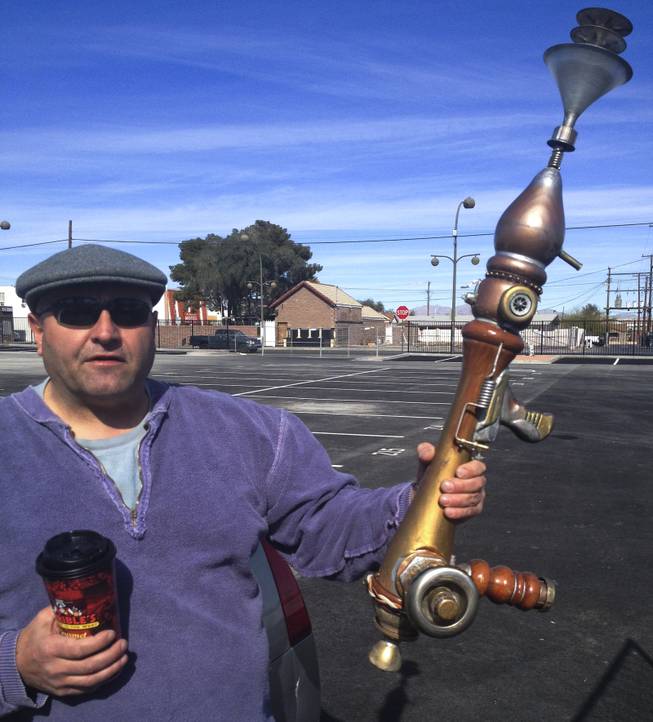 Sheet metal worker Anthony Calderone, lured by the Life Cube, shows off his the steampunk gun he fashioned from all sorts of discarded items of various shapes and sizes Tuesday, Feb. 4, 2014.
