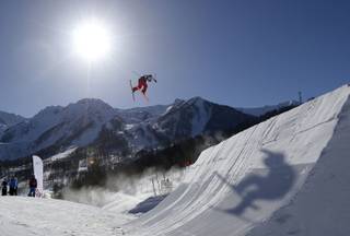 A competitor takes a jump during a ski slopestyle training session at the Rosa Khutor Extreme Park, prior to the 2014 Winter Olympics, Tuesday, Feb. 4, 2014, in Krasnaya Polyana, Russia. 