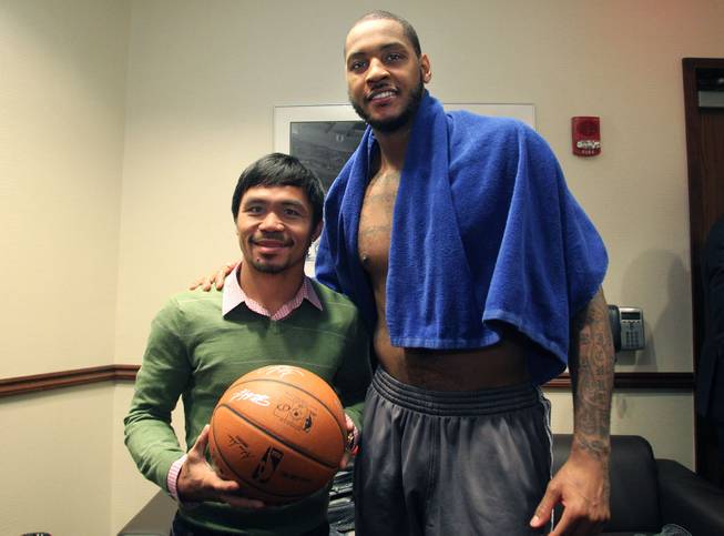 Feb.  5, 2014, New York,NY   ---   Manny Pacquiao receives a signed game ball from New York Knicks forward Carmelo Anthony (R) in the locker room after the  New York Knicks - Portland Trail Blazers NBA basketball game at Madison Square Garden in New York City Wednesday night. Pacquaio was in town as part of a two-city media tour to announce his upcoming rematch against undefeated WBO World Welterweight  champion Timothy Bradley.  Pacquiao vs. Bradley 2 will take place, Saturday, April 12 at the MGM Grand Garden Arena in Las Vegas. Chris Farina - Top Rank