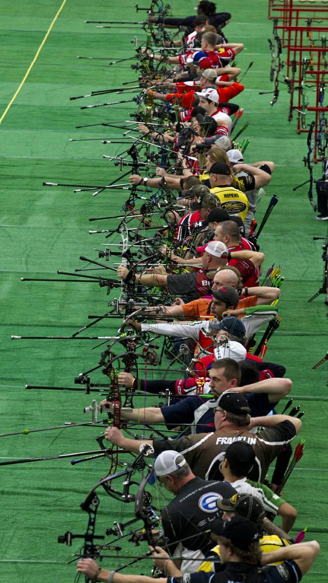 Competitors launch arrows during the Adult Freestyle Championship in the South Point Arena as part of the Vegas Round of the 2014 NFAA World Archery Festival on Friday, Feb. 7, 2014.