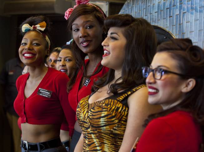 The Pin-Up Pizza girls are entertained by pizza tossers as they gather to celebrate the grand opening Friday, Feb. 7, 2014.