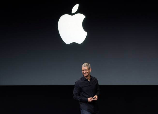 In this Tuesday, Sept. 10, 2013, file photo, Apple CEO Tim Cook speaks on stage before a new product introduction in Cupertino, Calif. Apple has reportedly repurchased $14 billion of its stock in the two weeks after its first-quarter financials and second-quarter revenue outlook disappointed investors. Its shares climbed in premarket trading Friday, Feb. 7, 2014.