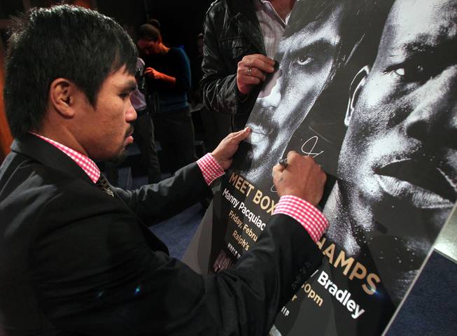 Feb. 7, 2014, Philadelphia, Pa.   ---  "STANDING ROOM ONLY" ---  Manny Pacquiao(pictured signing a fight poster) and undefeated WBO World Welterweight  champion Timothy Bradley make a special meet 'n greet appearance for hundreds of employees at Comcast global headquarters in downtown Philadelphia,Pa. on the final stop of their media tour. The boxers are in town to promote their upcoming rematch on Saturday, April 12 at the MGM Grand Garden Arena in Las Vegas. Chris Farina - Top Rank