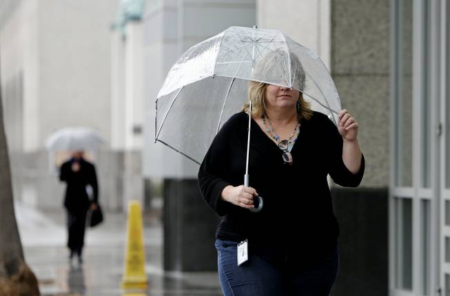 Molly Emslie found the need for an umbrella as showers swept through Sacramento, Calif., on Friday, Feb. 7, 2014. Drought-stricken California is getting some relief as a storm system the likes of which, forecasters say, the region has not seen in more than a year.