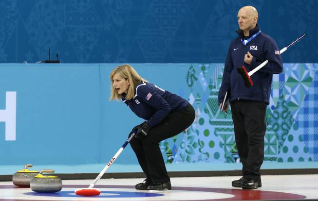 Erika Brown, skip of Team USA, shouts instructions as coach Derek Brown (no relation) looks on during women's training at the the 2014 Winter Olympics on Saturday, Feb. 8, 2014, in Sochi, Russia.