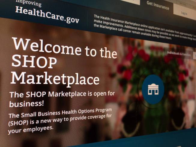 This Nov. 27, 2013, file photo shows part of the HealthCare.gov website page featuring information about the SHOP Marketplace. Trying to limit election-year damage on health care, the Obama administration Monday, Feb. 10, 2014, granted business groups another delay in a much-criticized requirement that larger firms cover their workers or face fines.