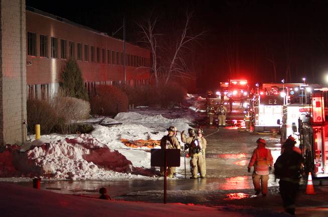 Emergency crews from several towns work an area outside the New Hampshire Ball Bearing plant after an explosion, Monday, Feb. 10, 2014, in Peterborough, N.H.