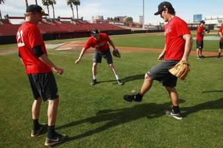 From left, UNLV baseball players Erick Fedde, Eric van Meetren and John Richy juggle a baseball with their feet and gloves during a media availability day Tuesday, Feb 11, 2014.