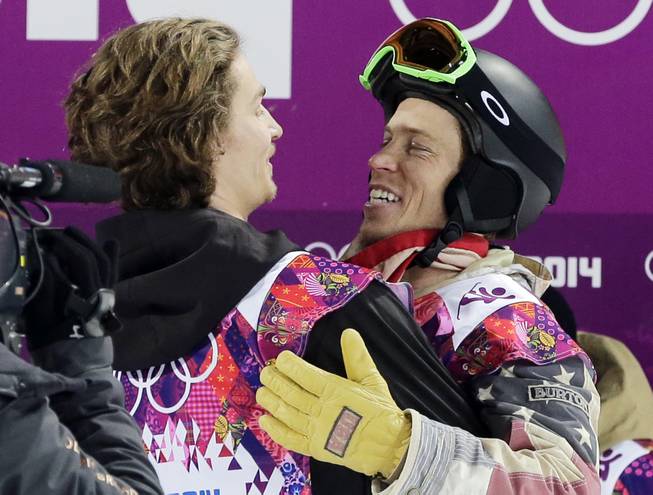 Switzerland's Iouri Podladtchikov, left, celebrates with Shaun White of the United States after Podladtchikov won the gold medal in the men's snowboard halfpipe final at the Rosa Khutor Extreme Park, at the 2014 Winter Olympics, Tuesday, Feb. 11, 2014, in Krasnaya Polyana, Russia.