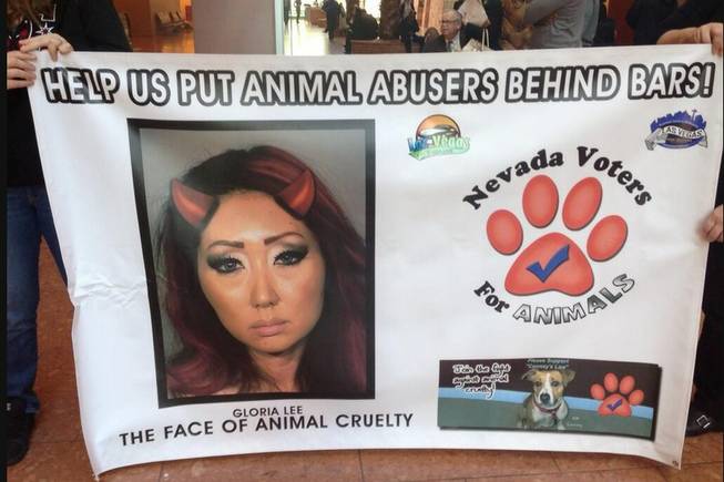 Protesters with Nevada Voters for Animals hold a banner declaring Gloria Lee as "the face of animal cruelty." Lee is accused of setting her Las Vegas pet shop on fire on Jan. 27. The protesters are turning out for court hearings in  Lee’s case to send a message to the judge that they want the harshest treatment possible for Lee. 