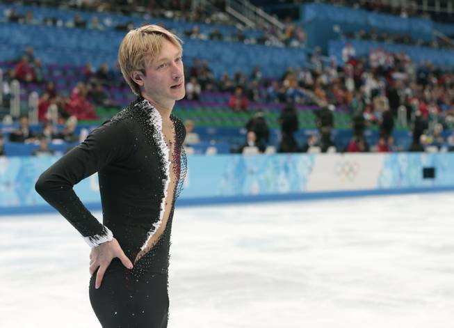 Evgeni Plushenko of Russia leaves the ice after pulling out of the men's short program figure skating competition due to illness at the Iceberg Skating Palace during the 2014 Winter Olympics, Thursday, Feb. 13, 2014, in Sochi, Russia.