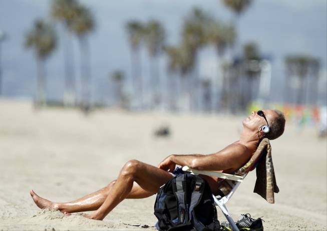 Venice Beach resident David Lomax enjoys the warm weather in the Venice Beach area of Los Angeles, Friday, Feb. 14, 2014. With much of the Northeast gripped by snow and ice storms, the Southwest is riding a heat wave that is setting record high temperatures and sent people to beaches and golf courses in droves Friday. 