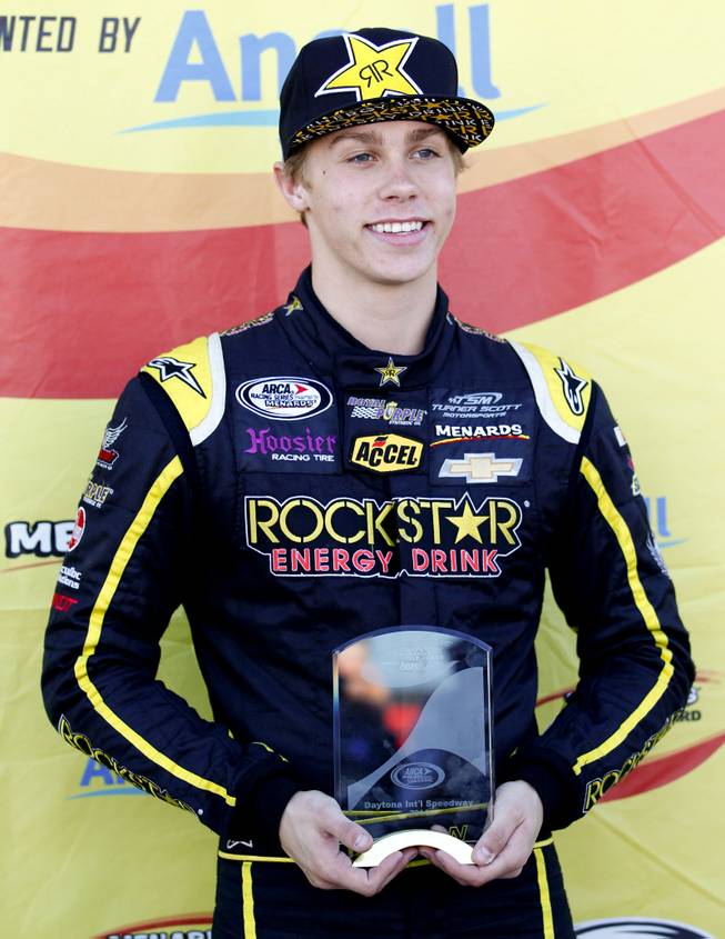 Driver Dylan Kwasniewski poses for photos with his trophy in the garages after winning the pole position for the ARCA Series race at Daytona International Speedway in Daytona Beach, Fla., Friday, Feb. 14, 2014. 