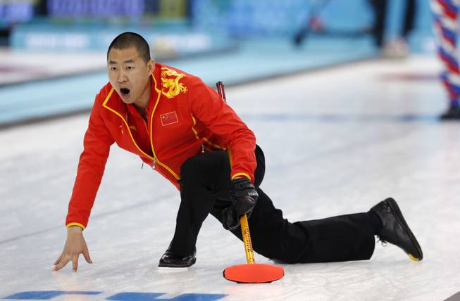 China's skip Liu Rui shouts to his weepers after delivering the rock during men's curling competition against Norway at the 2014 Winter Olympics, Friday, Feb. 14, 2014, in Sochi, Russia. 