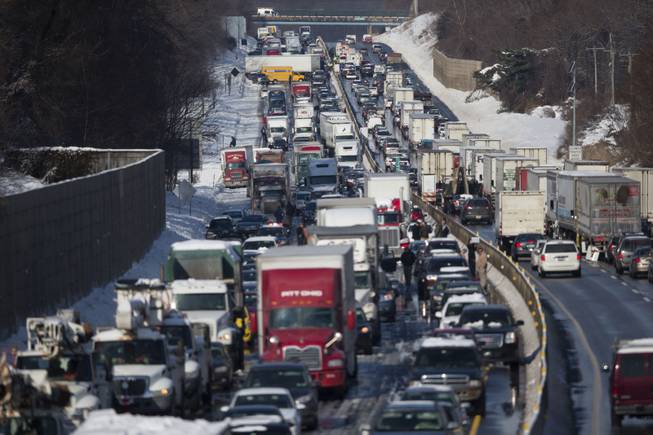 Vehicles are piled up in an accident Friday, Feb. 14, 2014, in Bensalem, Pa. Traffic accidents involving multiple tractor trailers and dozens of cars have completely blocked one side of the Pennsylvania Turnpike outside Philadelphia and caused some injuries.