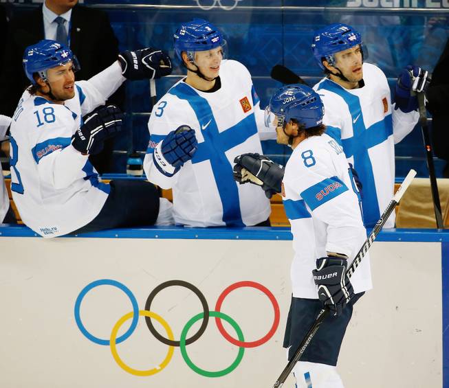 Finland forward Teemu Selanne (8) is congratulated by his teammates after scoring a goal against Norway during the 2014 Winter Olympics men's ice hockey game at Shayba Arena, Friday, Feb. 14, 2014, in Sochi, Russia.