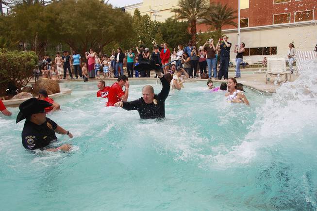 Participants leap into the pool during the Fifth Annual Special Olympics Las Vegas Polar Plunge Saturday, Feb. 15, 2014 at the South Point.