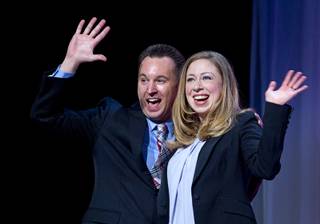 Vinnie Pompei, conference chair and director of the Human Rights Campaign Foundation's Youth Well-Being Project, and Chelsea Clinton wave after closing remarks during HRC's Time to Thrive conference at Bally's on Sunday, Feb. 16, 2014.