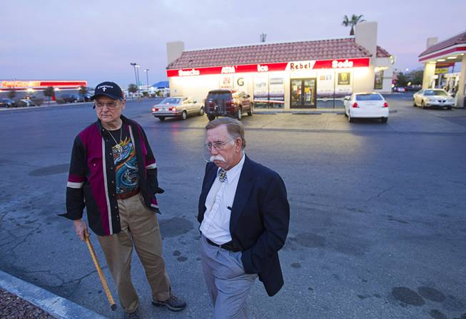 Volunteers Barry Mainardi, left, a chaplain with Messages of Faith Ministry, and Edward Cotton wait outside a Rebel Station during a search for information on Jessie Foster continues Monday, Feb. 17, 2014. Foster, a Canadian, went missing from North Las Vegas in 2006.