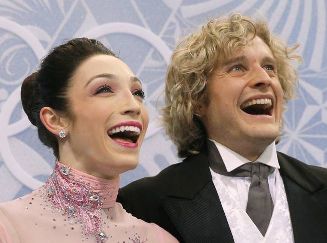 Meryl Davis and Charlie White of the United States smile as they wait in the results area after competing in the ice dance short dance figure skating competition at the Iceberg Skating Palace during the 2014 Winter Olympics, Sunday, Feb. 16, 2014, in Sochi, Russia.