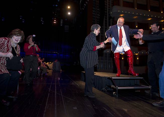 Myron Martin, president/CEO of the Smith Center for the Performing Arts, gets help leaving the stage after announcing the 2014-2015 Broadway Las Vegas Series at the Center Tuesday, Feb. 18, 2014. The Tony Award-winning "Kinky Boots" will be coming to the Smith Center in September.