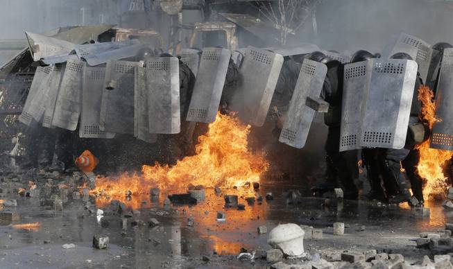 Riot police clash with anti-government protesters outside Ukraine's parliament in Kiev, Ukraine, Tuesday, Feb. 18, 2014.  Some thousands of anti-government protesters clashed with police in a new eruption of violence Tuesday. 