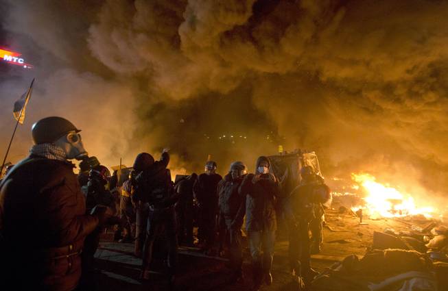 Anti-government protesters clash with riot police in Kiev's Independence Square, the epicenter of the country's current unrest,  Kiev, Ukraine, Tuesday, Feb. 18, 2014.