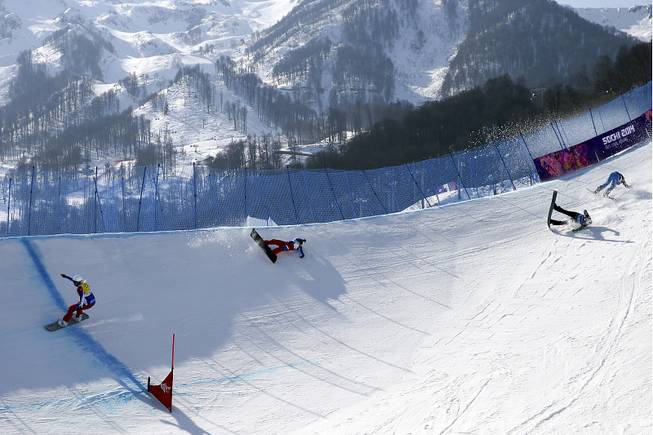 A crash during the second heat of the women's snowboard cross quarterfinals at Rosa Khutor Extreme Park in Krasnaya Polyana, Russia, on Sunday, Feb. 16, 2014. 