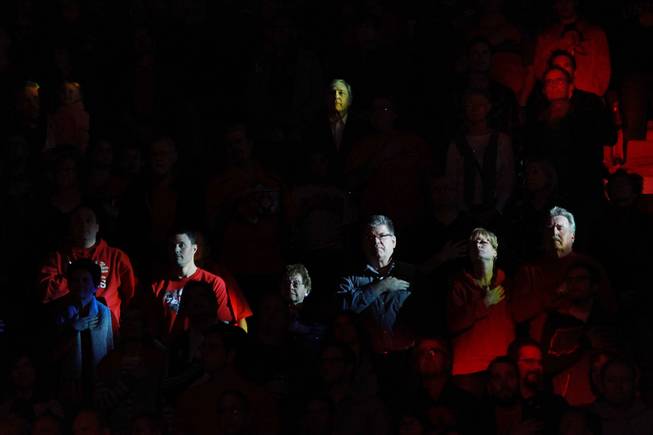 UNLV fans are lit by moving lights during the playing of the national anthem before the Rebels game against New Mexico Wednesday, Feb. 19, 2014 at the Thomas & Mack Center.