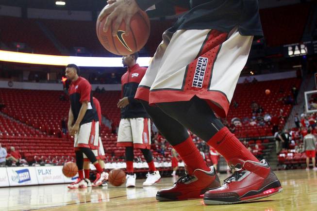 UNLV guard Kevin Olekaibe sports shoes featuring lights in the heels and Hey Reb on the tongue while the Rebels warm up for their game against New Mexico Wednesday, Feb. 19, 2014 at the Thomas & Mack Center.