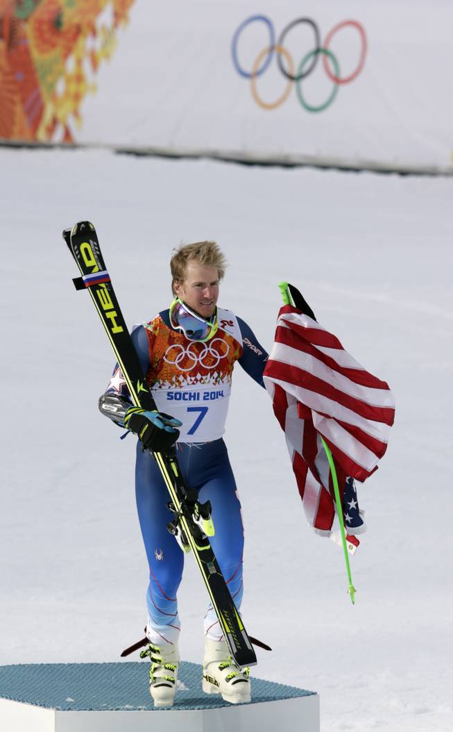 Men's giant slalom gold medalist Ted Ligety of the United States leaves the podium after a flower ceremony at the Sochi 2014 Winter Olympics, Wednesday, Feb. 19, 2014, in Krasnaya Polyana, Russia. 