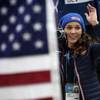 American bobsledder Lolo Jones takes pictures of her teammates after they won silver and bronze during the women's bobsled competition at the 2014 Winter Olympics, Wednesday, Feb. 19, 2014, in Krasnaya Polyana, Russia. 