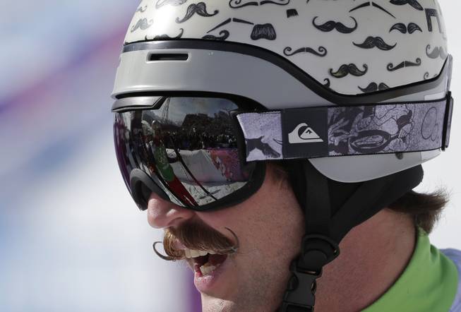 Moustaches are painted on the helmet of Slovenia's Filip Flisar during men's ski cross competition at the Rosa Khutor Extreme Park, at the 2014 Winter Olympics, Thursday, Feb. 20, 2014, in Krasnaya Polyana, Russia. 
