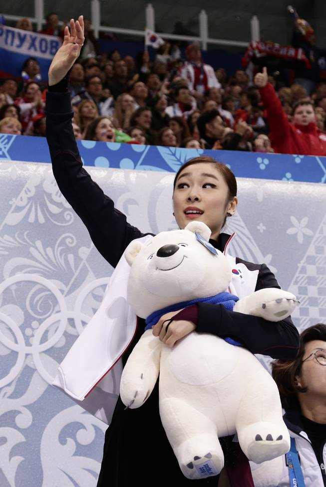 Yuna Kim of South Korea waves to spectators in the results area after completing her routine in the women's free skate figure skating finals at the Iceberg Skating Palace during the 2014 Winter Olympics, Thursday, Feb. 20, 2014, in Sochi, Russia. 