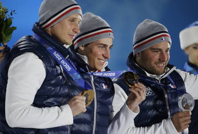 Men's skicross medalists, from left, Jonathan Midol, bronze, Jean Frederic Chapuis, gold, and Arnaud Bovolenta, silver, all from France, pose with their medals at the 2014 Winter Olympics in Sochi, Russia, Thursday, Feb. 20, 2014.