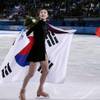 Yuna Kim of South Korea and Adelina Sotnikova of Russia skate on the ice after the flower ceremony for the women's free skate figure skating finals at Iceberg Skating Palace during the 2014 Winter Olympics, Thursday, Feb. 20, 2014, in Sochi, Russia. 