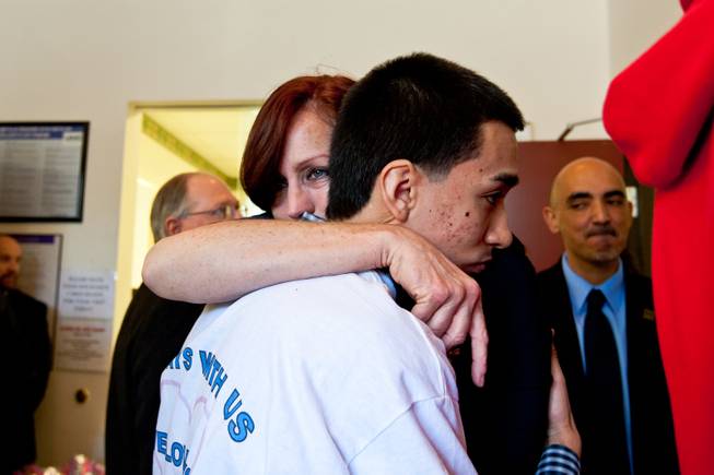 Reuben Moran, a close friend of Aric Brill, hugs Karen Brill during a ceremony celebrating the life of her son 16-year-old Aric Michael Brill, who donated six organs following his homicide five years ago, at the UMC Transplant Center Friday, February 21, 2014.