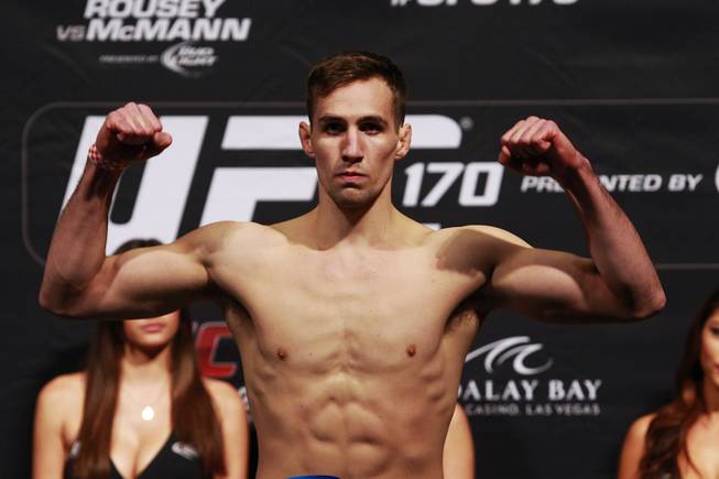 Welterweight Rory MacDonald flexes after making weight during the weigh in for UFC 170 Friday, Feb. 21, 2014 at the Mandalay Bay Events Center.
