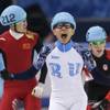Victor An of Russia, center, reacts as he crosses the finish line ahead of Wu Dajing of China, left, and Charle Cournoyer of Canada in the men's 500m short track speedskating final at the Iceberg Skating Palace during the 2014 Winter Olympics, Friday, Feb. 21, 2014, in Sochi, Russia.