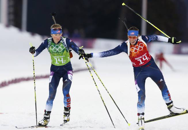United States' Susan Dunklee, right, changes to Hannah Dreissigacker during the women's biathlon 4x6k relay, at the 2014 Winter Olympics, Friday, Feb. 21, 2014, in Krasnaya Polyana, Russia. (AP Photo/Dmitry Lovetsky)