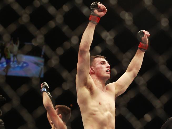 Rory MacDonald raises his arms in victory after defeating Demian Maia at UFC 170 Saturday, Feb. 22, 2014 at the Mandalay Bay Events Center.