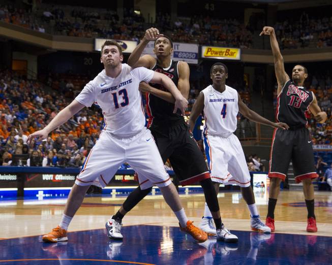 Players battle for position during a free throw by Bryce Dejean-Jones, right, in UNLV's 91-90 overtime loss to Boise State at Taco Bell Arena in Boise on Saturday, Feb. 22, 2014.