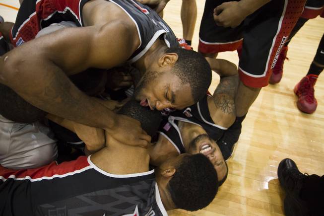 UNLV players celebrate, thinking they had won the game, but officials ruled that Deville Smith's apparent game-winning shot didn't count. UNLV lost 91-90 to Boise State at Taco Bell Arena in Boise on Saturday, Feb. 22, 2014.