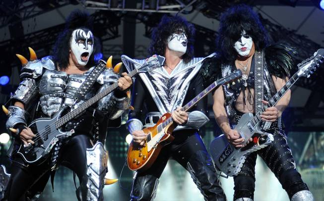 In this Thursday June 13, 2013, file photo, from left: bassist Gene Simmons , guitarist Tommy Thayer and singer Paul Stanley of the US band Kiss perform on stage in Berlin, Germany. Kiss announced Sunday, Feb. 23, 2014 that the band will not perform when they are inducted into the Rock and Roll Hall of Fame in Cleveland in April. The 40-year-old band is unable to agree on which lineup should perform during the April 10 ceremony in New York City.