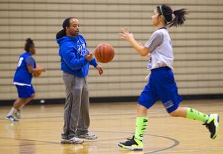 Coach Lonnie Cambell passes a ball to Heaven Heacock during practice at Desert Pines High School Monday, Feb. 24, 2014.