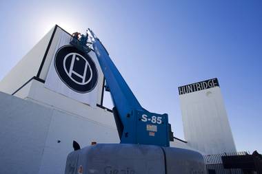 Workers hang a banner with a Huntridge logo at the Huntridge Theater at Maryland Parkway and Charleston Boulevard Monday, Feb. 24, 2014.