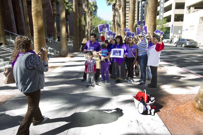 Rally members take a group photo as they try to increase awareness of domestic violence outside Clark County Regional Justice Center Monday, Feb. 24, 2014.