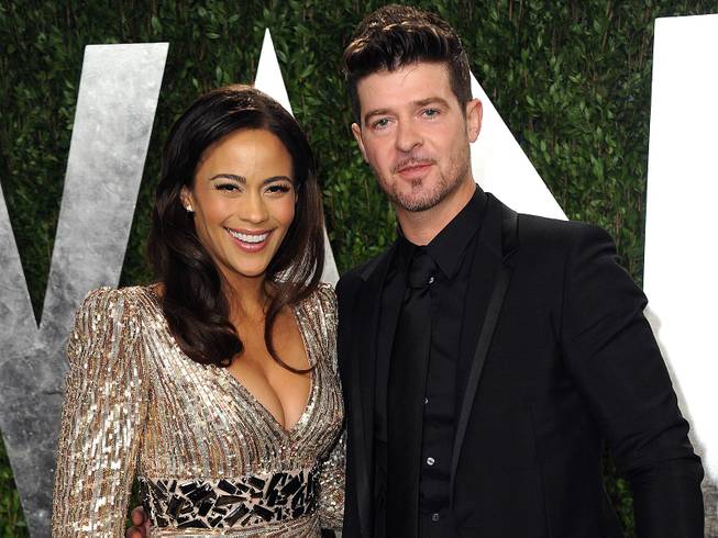 Paula Patton and Robin Thicke arrive at the 2013 Vanity Fair Oscars Viewing and After Party at the Sunset Plaza Hotel in West Hollywood, Calif., on Sunday, Feb. 24, 2013.