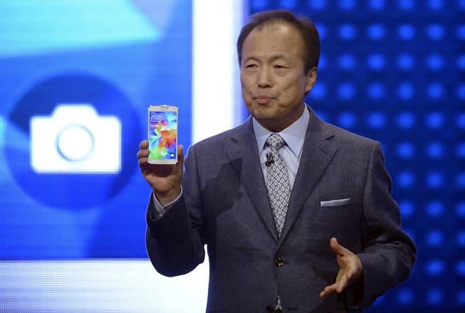 Samsung CEO J.K. Shin presents the new Samsung Galaxy S5 at the Mobile World Congress, the world's largest mobile phone trade show in Barcelona, Spain, Monday, Feb. 24, 2014.